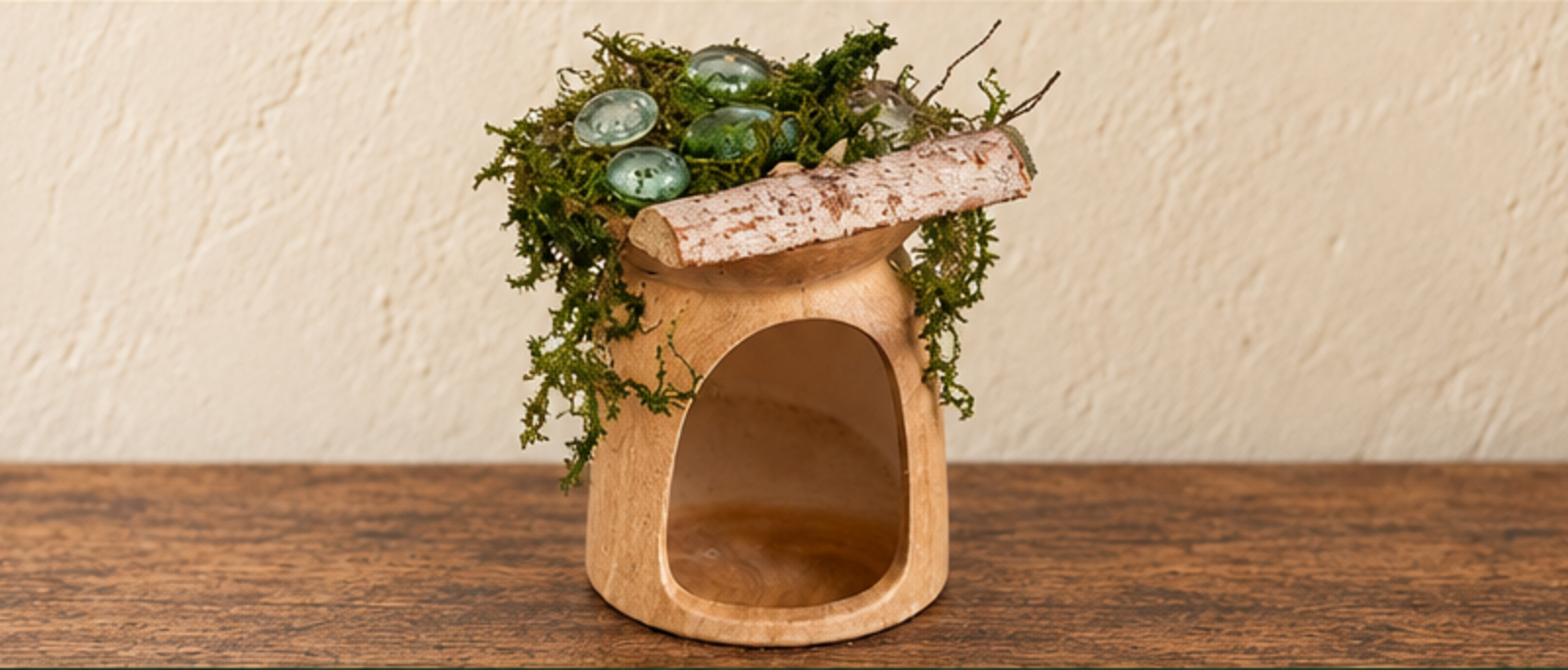 The first fairy-house roof made with moss, green glass pieces, and a birch half-log