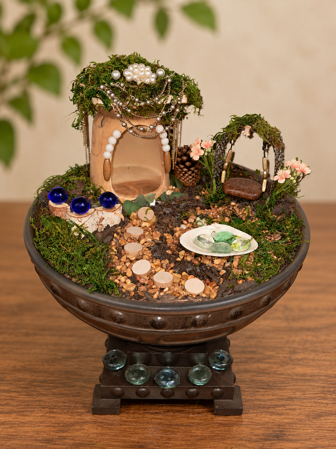 The current pedestal-bowl fairy world with its pearl-draped house, flowered swing, pathway, and shell pond